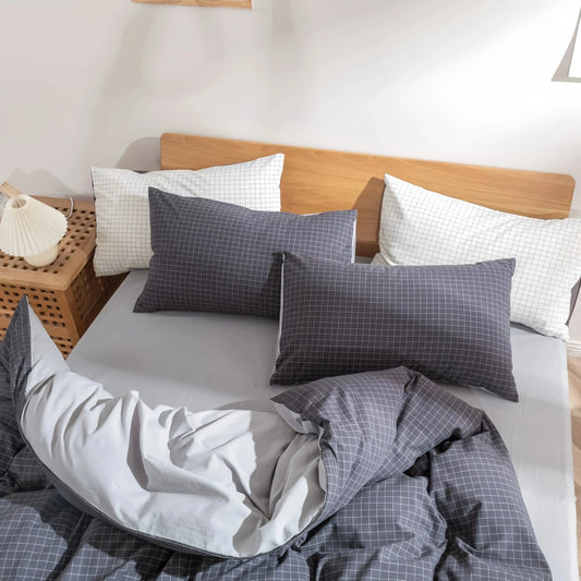 Gray and white grid pattern cotton doona cover set with matching pillowcases on a wooden bed